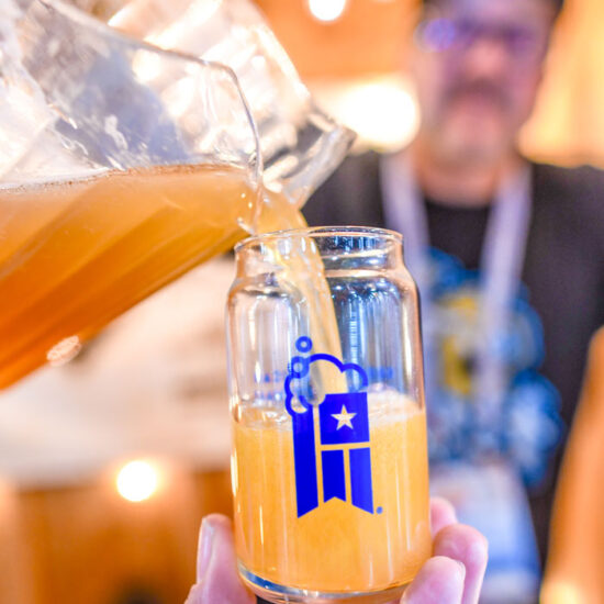 Beer being poured into a glass at the great american beer festival