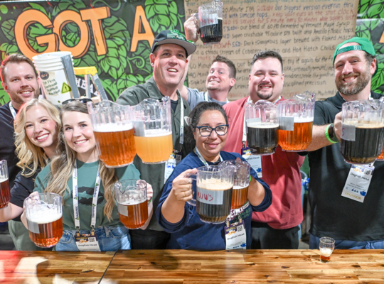 A group of people holding pitchers of beer
