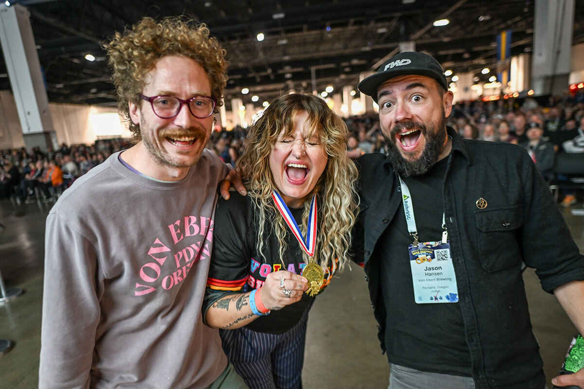 Three GABF medal winners posing with their medal