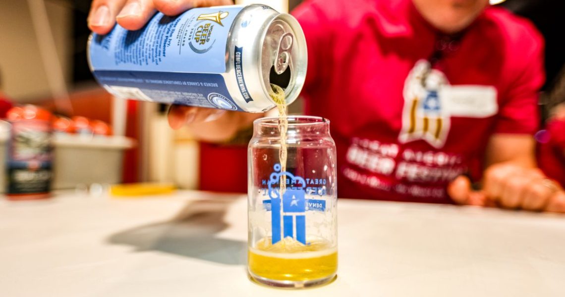 Beer being poured into a GABF taster cup