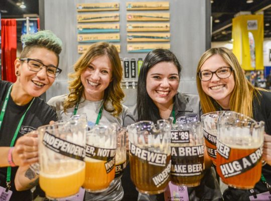 Brewery women holding beer pitchers