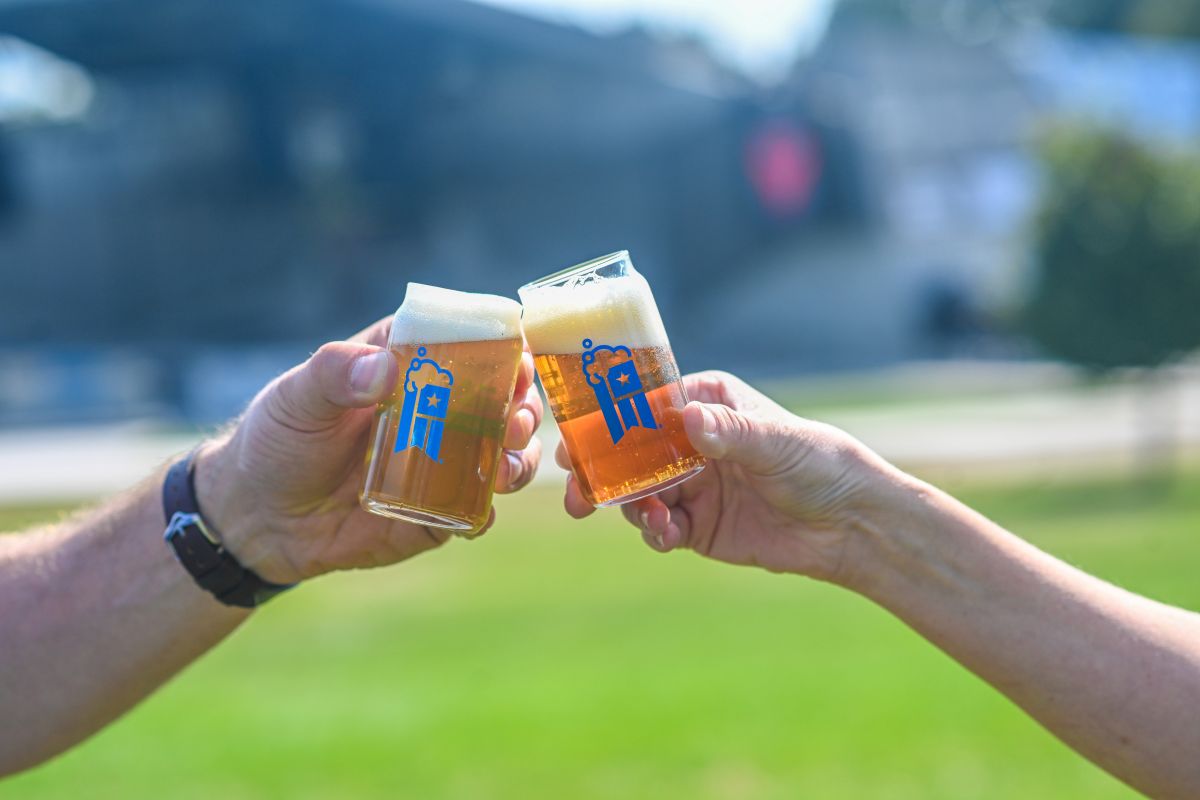 Two people clinking beer glasses